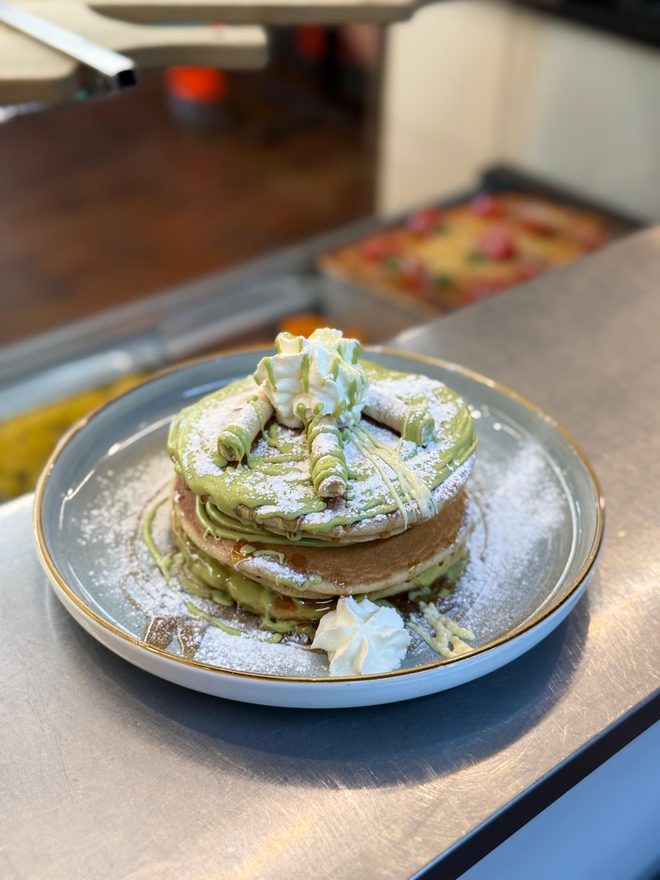 Pistachio pancakes on a grey plate