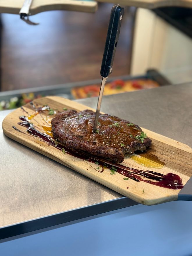 Sirloin steak on a board with a knife