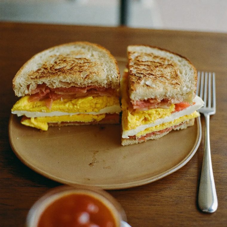 A toasted halloumi and egg sandwich on a plate